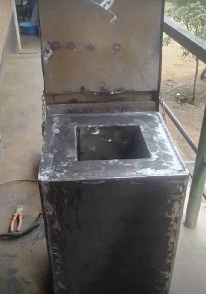 The first cooker assembled, with its hinged lid open